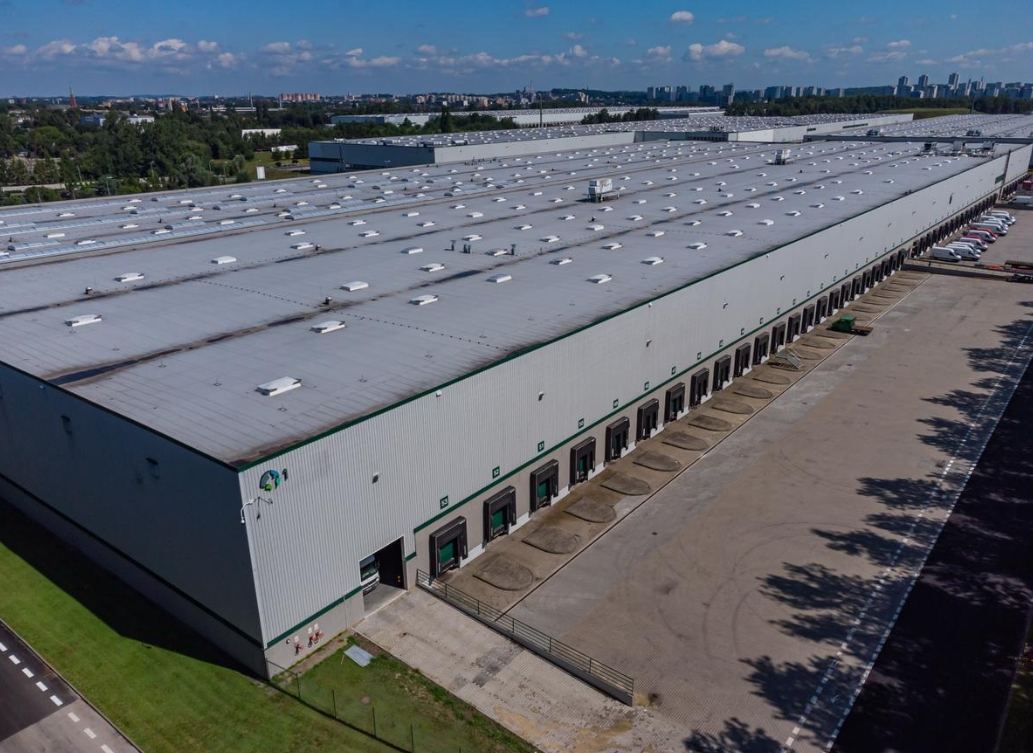 Large industrial warehouse with an extensive rooftop and multiple loading docks.